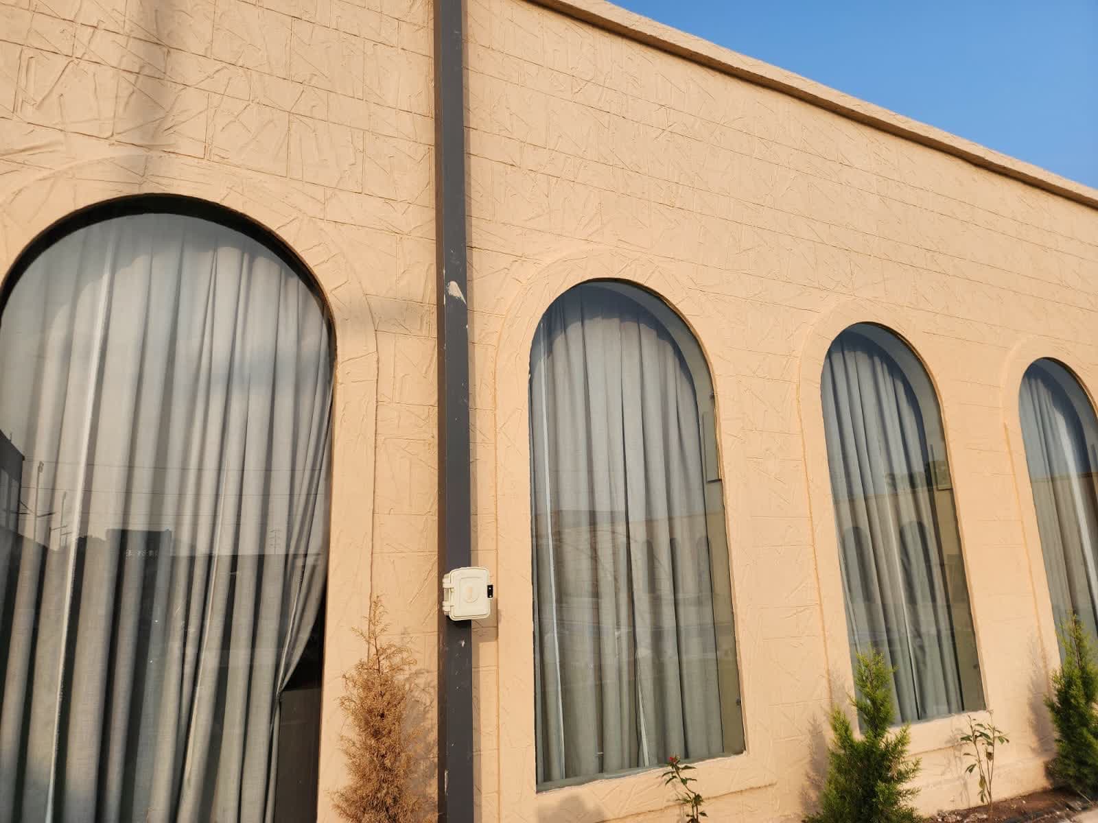 Finished cream exterior facade with arched window surrounds