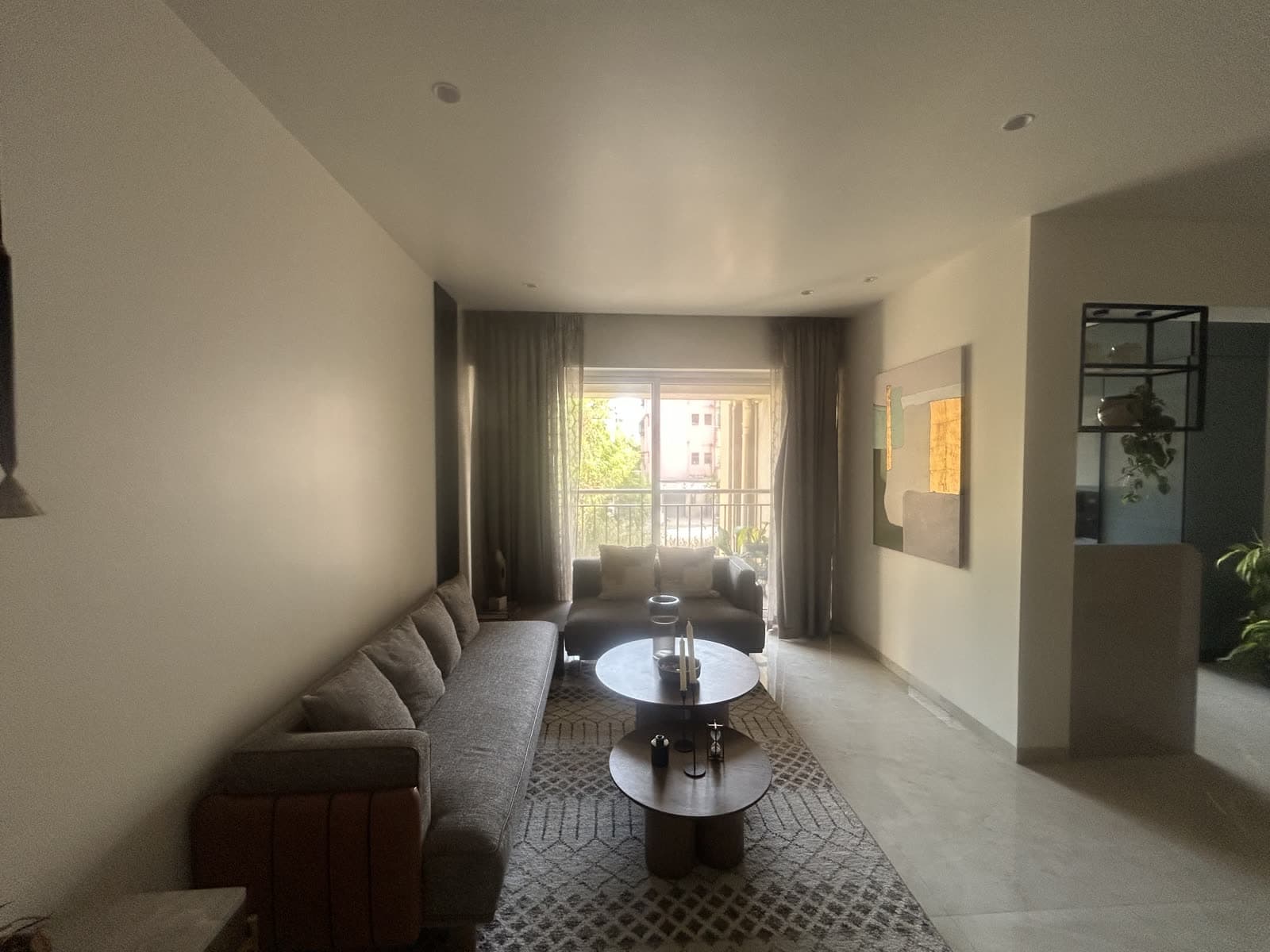 Finished modern living room with statement art and marble flooring