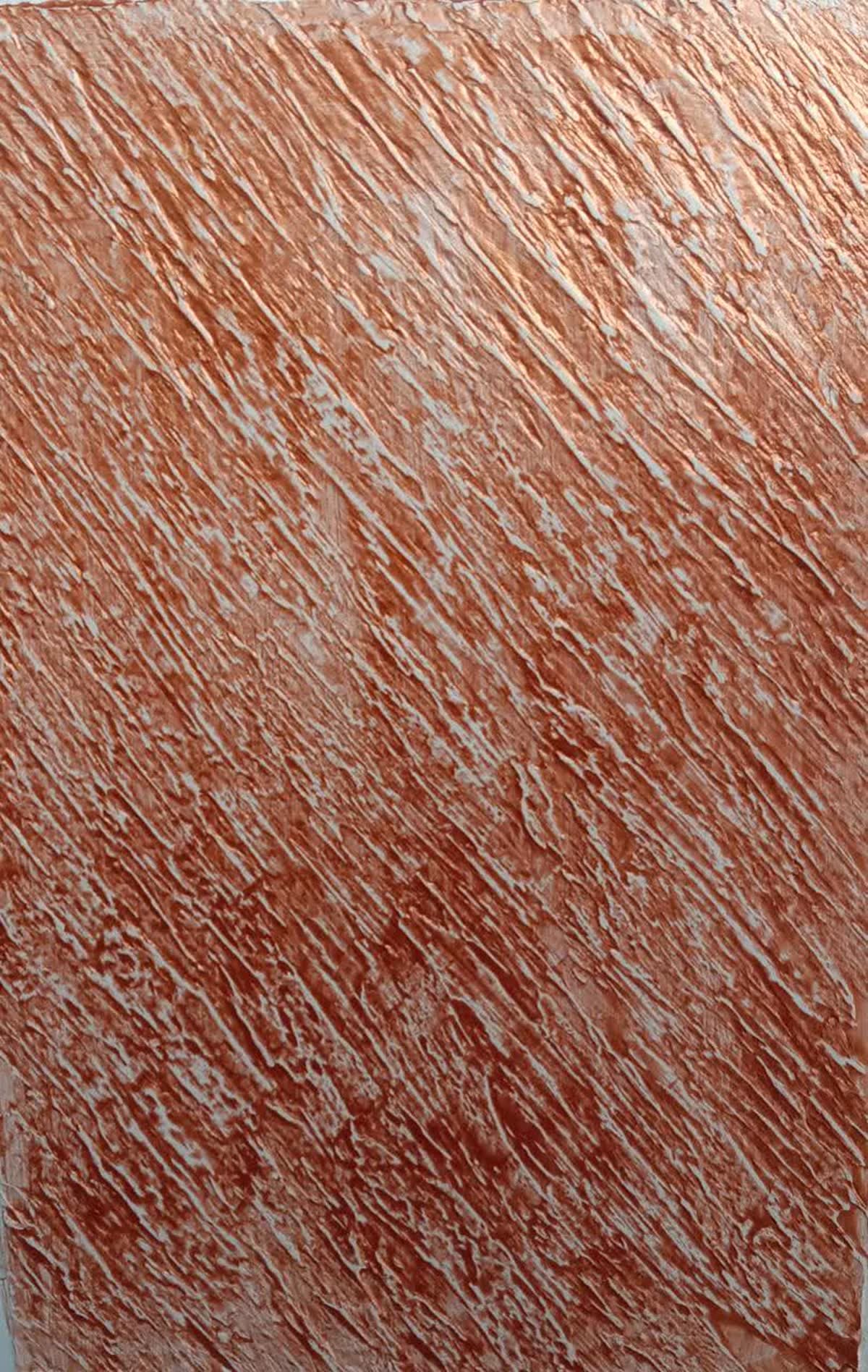Close-up of a brushed copper-tone decorative texture finish