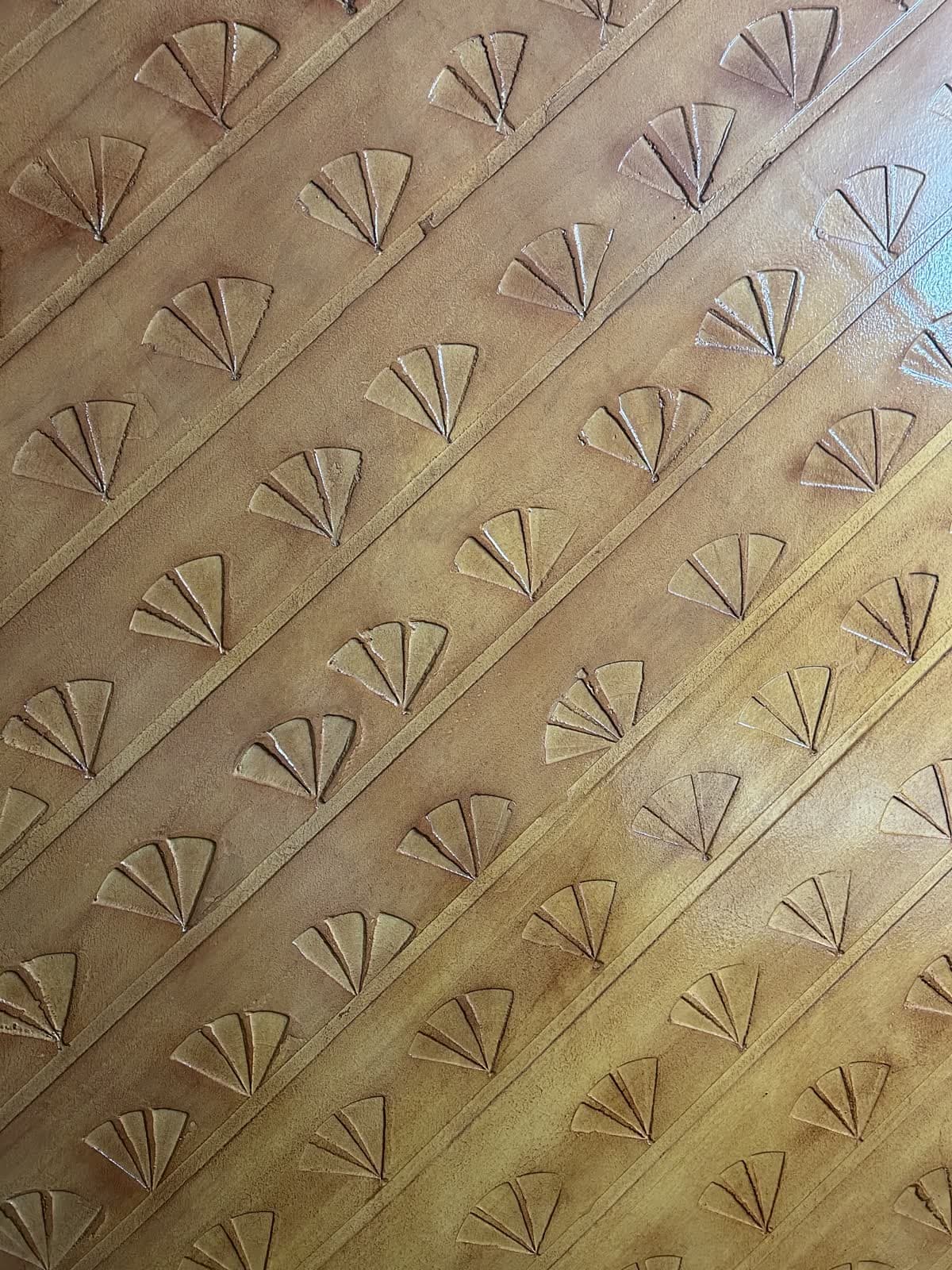 Close-up of a hand-carved fan-pattern wall texture